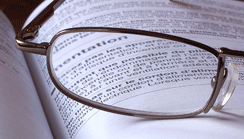 Picture of glasses on a book with french writing.